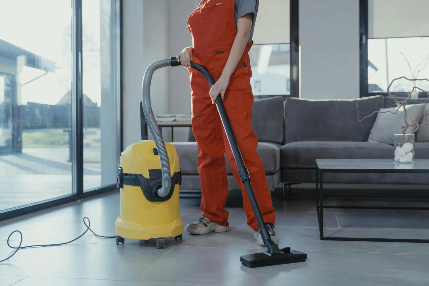 woman cleaning with the vacuum machine